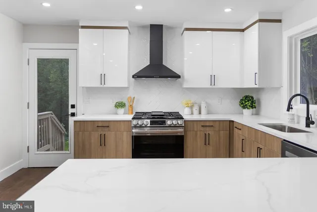 a kitchen with stainless steel appliances a sink stove and cabinets