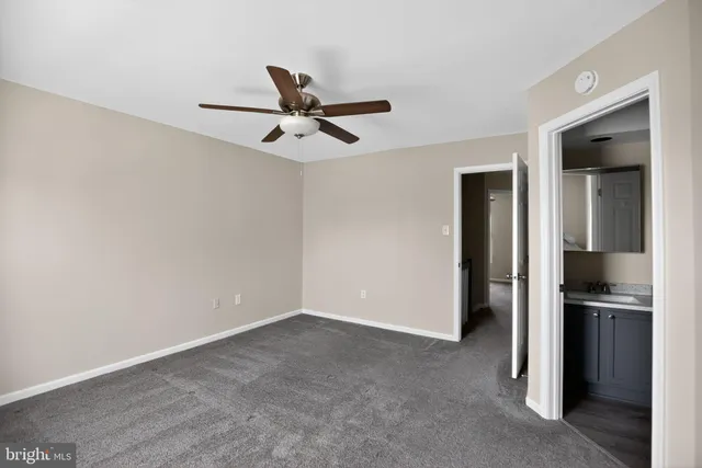 a view of a kitchen with a sink and refrigerator