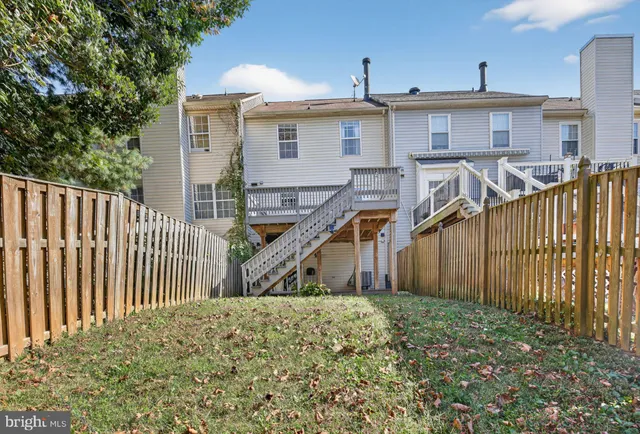 a view of a house with wooden fence