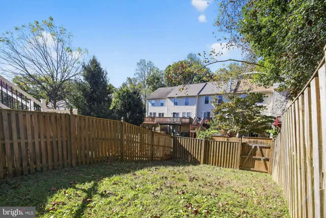 a view of a house with a wooden fence