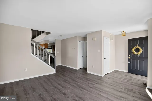 a view of an entryway with wooden floor