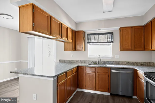 a kitchen with stainless steel appliances granite countertop a sink stove and cabinets