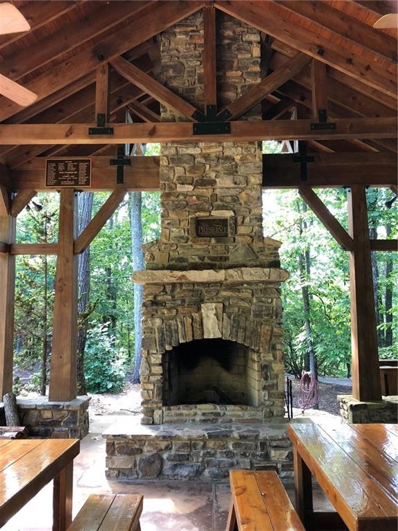 0 Talley Cove Road Jasper, GA 30143 - Photo 10 of 14 a outdoor space with lots of wooden furniture and a fireplace