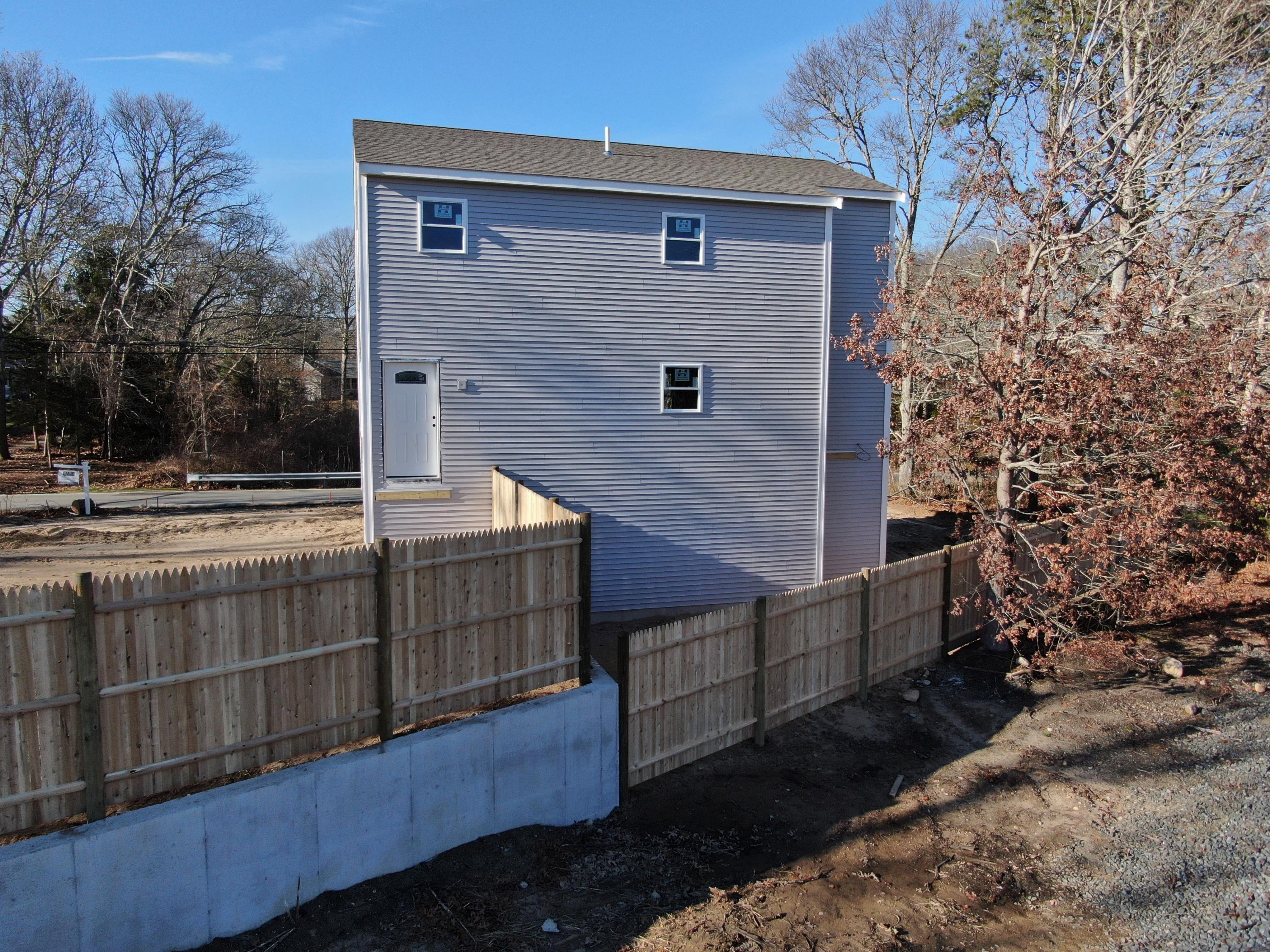 49 Monument Neck Road Buzzards Bay, MA 02532 - Photo 3 of 24 a front view of a house with a yard