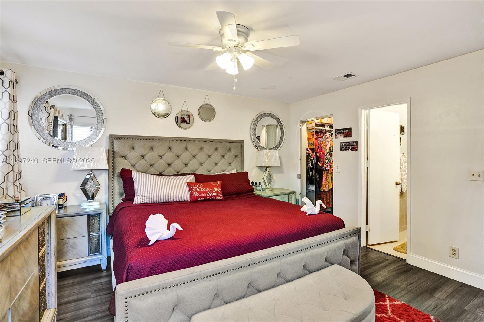 7780 Northwest 79th Avenue, Unit F6 Tamarac, FL 33321 - Photo 16 of 27 a bedroom with a bed and a chandelier