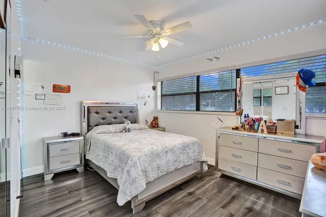 a bedroom with a bed dresser and a window