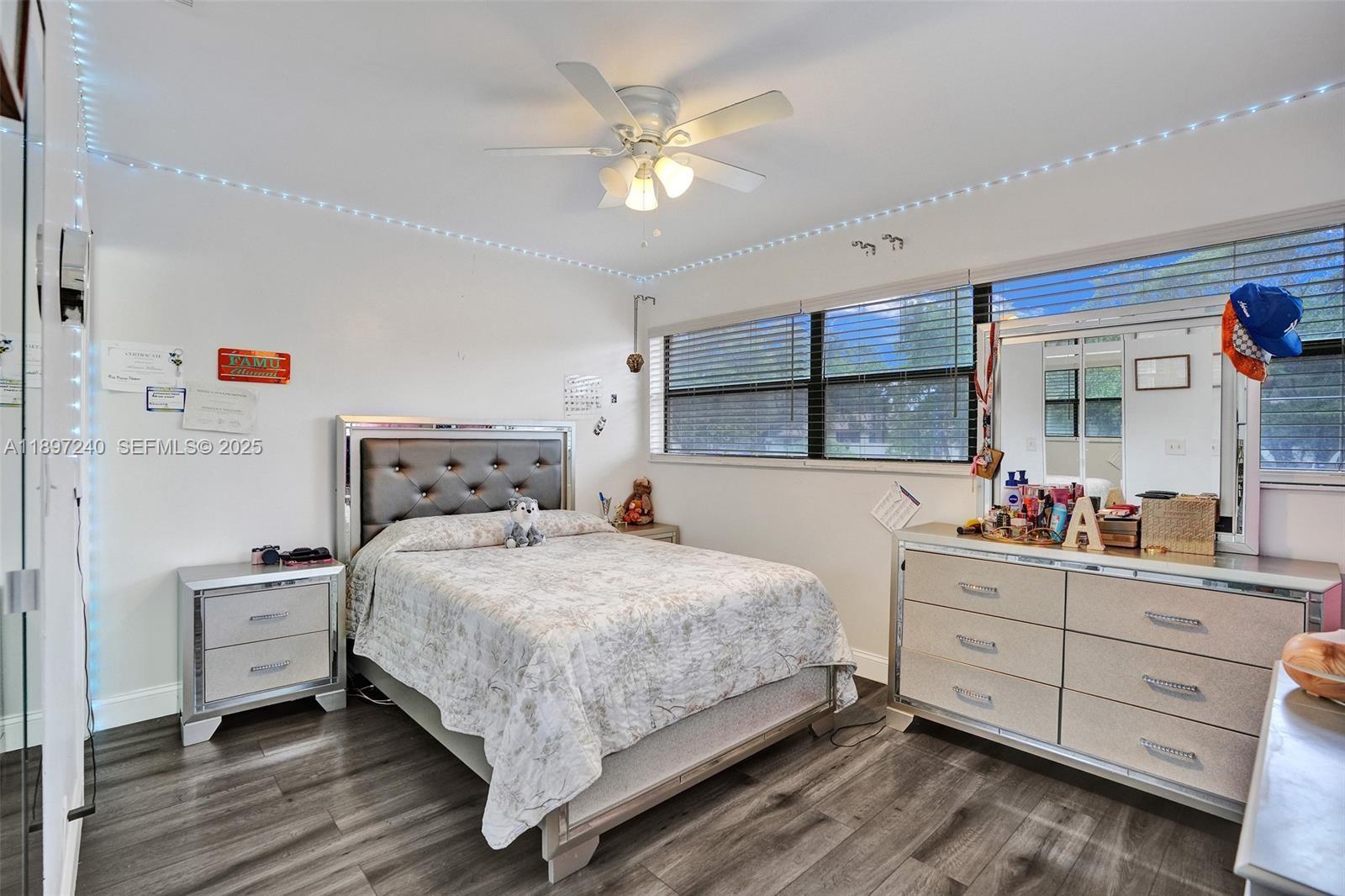 7780 Northwest 79th Avenue, Unit F6 Tamarac, FL 33321 - Photo 18 of 27 a bedroom with a bed and a dresser