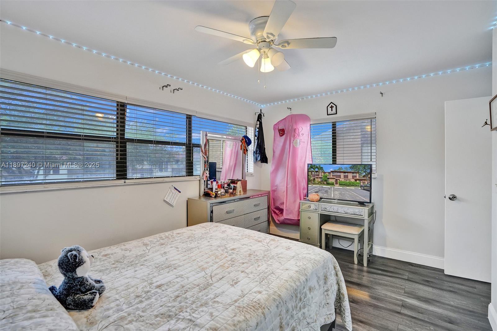 7780 Northwest 79th Avenue, Unit F6 Tamarac, FL 33321 - Photo 19 of 27 a bedroom with a bed dresser and a window