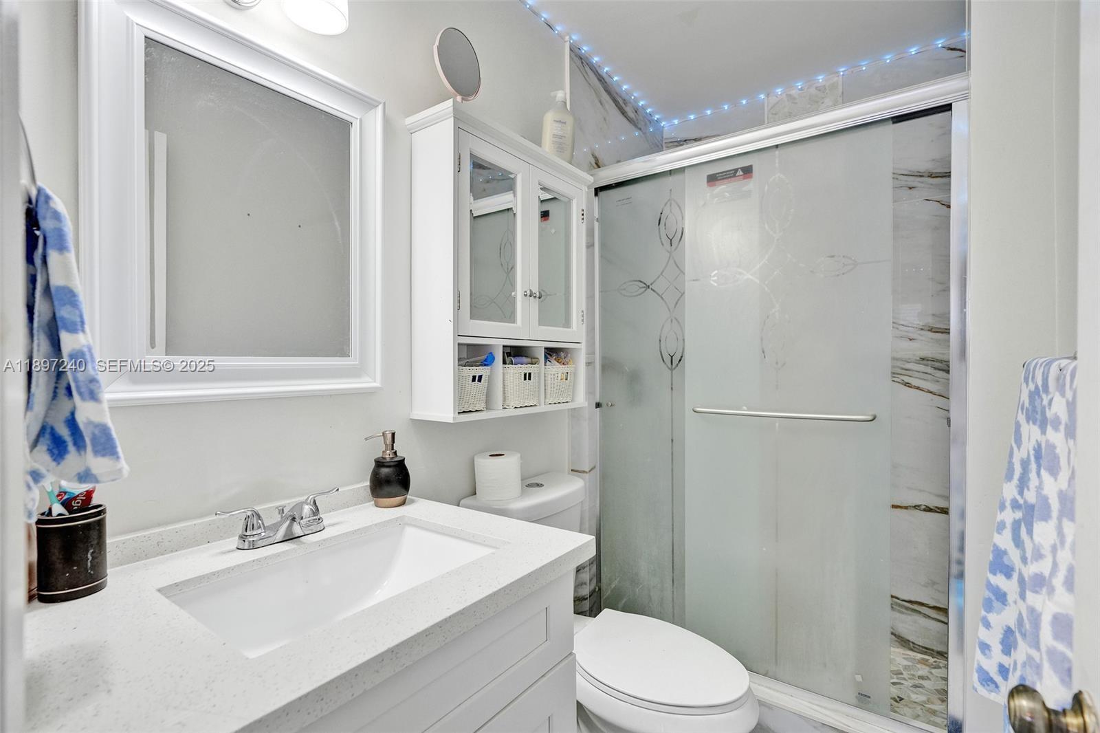 7780 Northwest 79th Avenue, Unit F6 Tamarac, FL 33321 - Photo 21 of 27 a bathroom with a sink toilet and shower