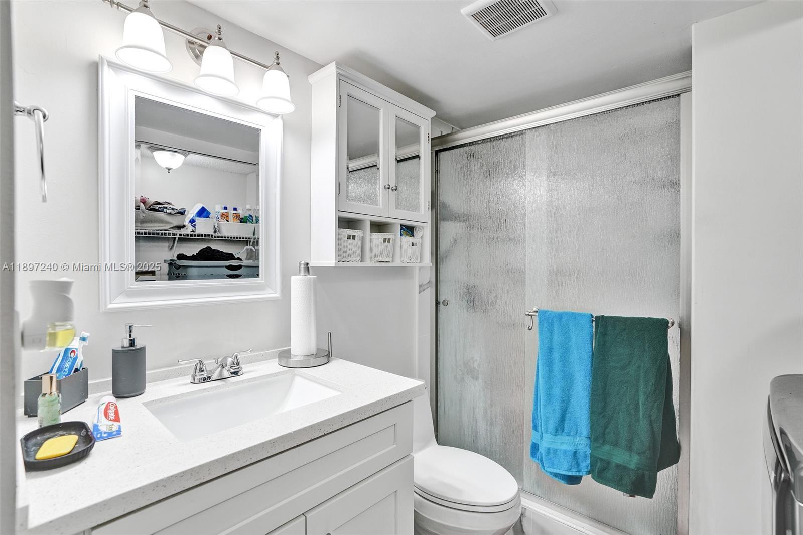 7780 Northwest 79th Avenue, Unit F6 Tamarac, FL 33321 - Photo 24 of 27 a bathroom with a sink a toilet and shower