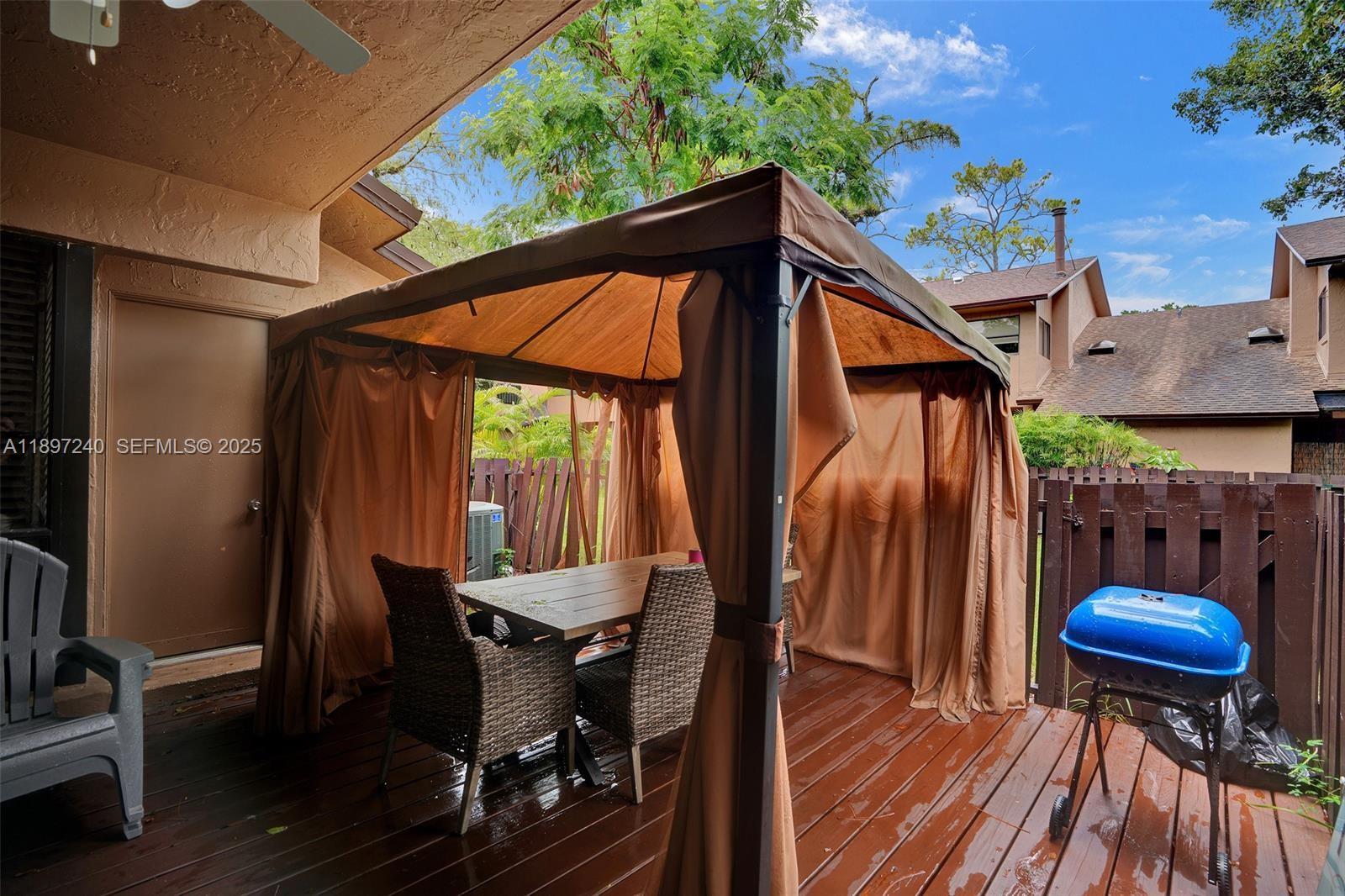 7780 Northwest 79th Avenue, Unit F6 Tamarac, FL 33321 - Photo 25 of 27 a view of a chairs and table in the patio