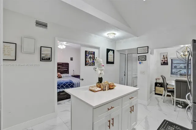 a kitchen with a sink cabinets and wooden floor