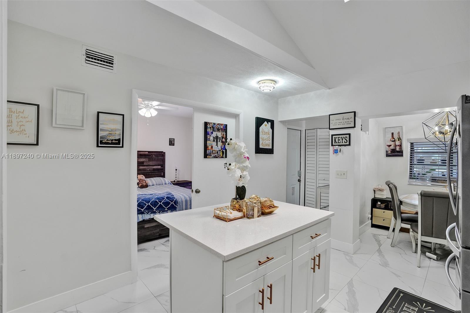 7780 Northwest 79th Avenue, Unit F6 Tamarac, FL 33321 - Photo 3 of 27 a kitchen with a sink cabinets and wooden floor