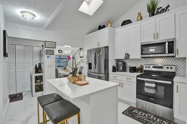 a kitchen with a sink a stove and refrigerator