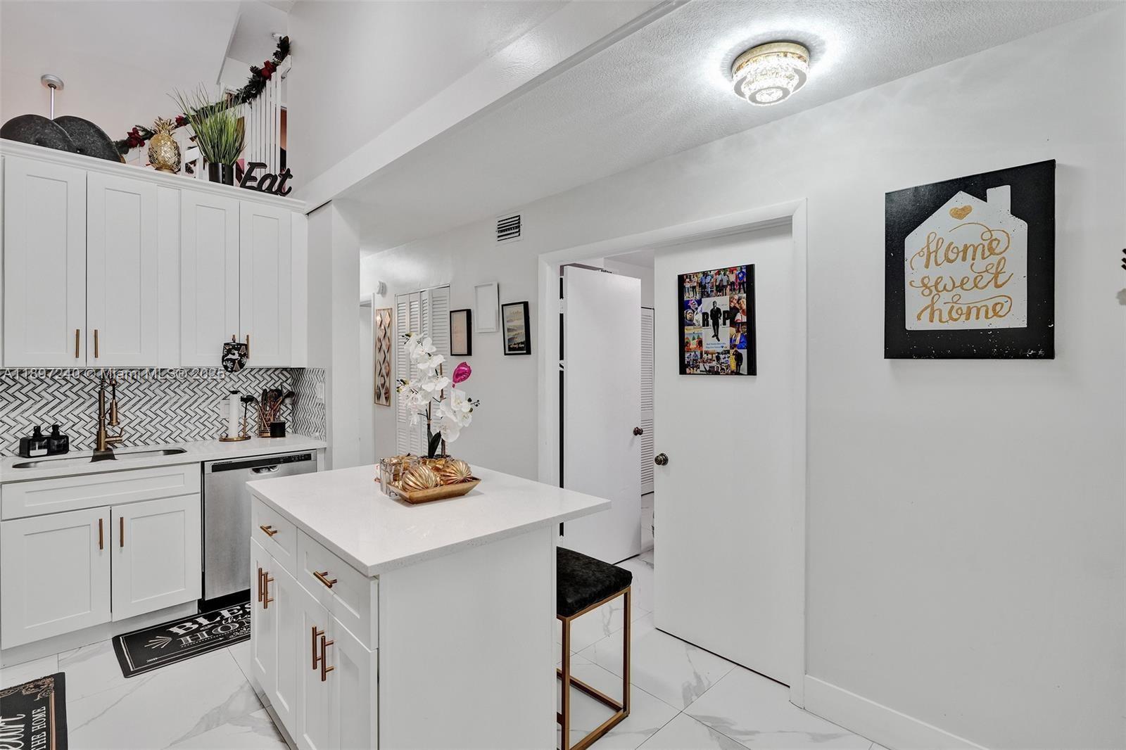 7780 Northwest 79th Avenue, Unit F6 Tamarac, FL 33321 - Photo 5 of 27 a kitchen with stainless steel appliances granite countertop a sink stove and cabinets