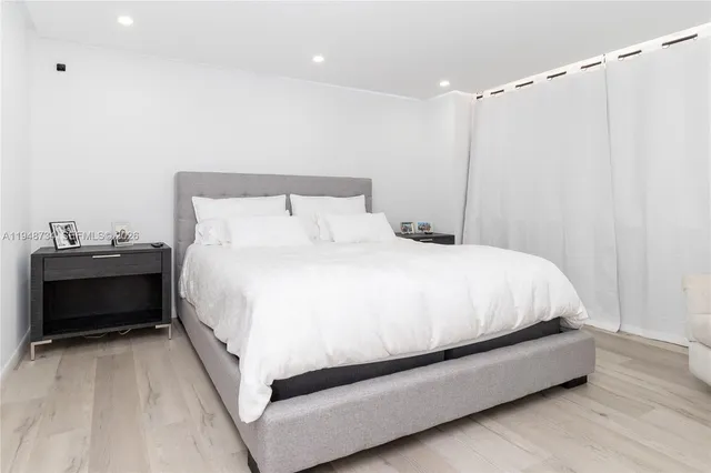 a bed room with a bed and a night stand