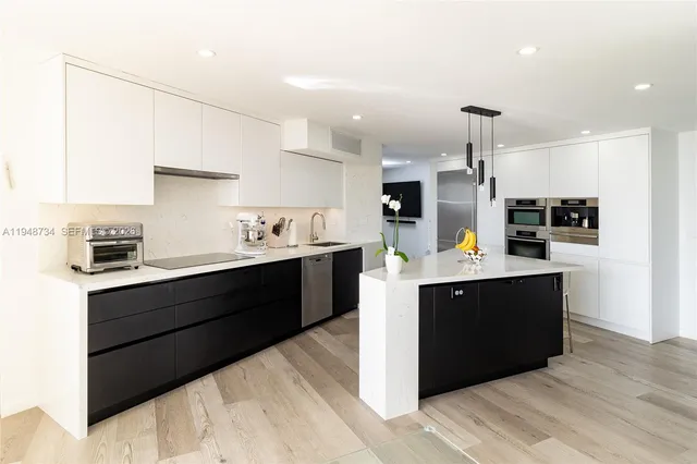 a kitchen with stainless steel appliances kitchen island granite countertop a sink and cabinets