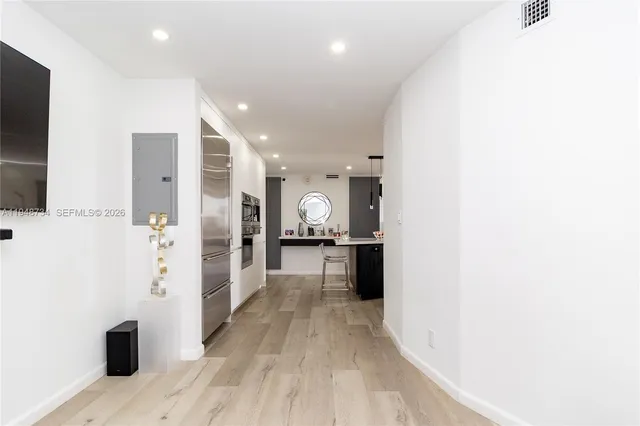 a view of a hallway with wooden floor