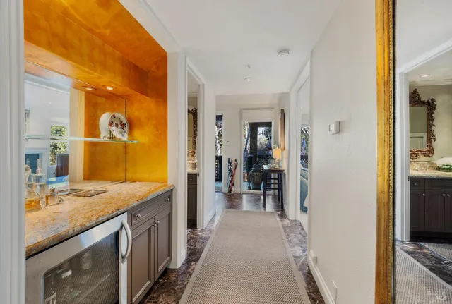 a bathroom with a granite countertop sink a mirror and a shower