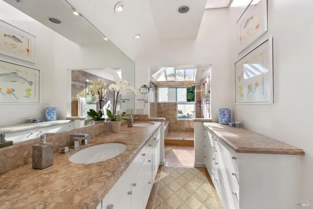 a large kitchen with granite countertop a sink a stove a dining table and chairs