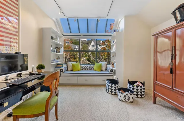 a dining room with furniture and a window