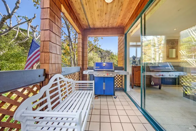 a patio with glass windows and furniture
