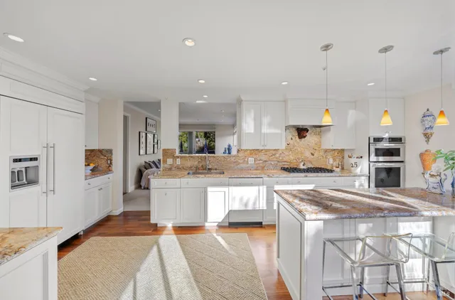 a large kitchen with a large counter top appliances and cabinets