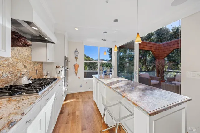 a kitchen with stainless steel appliances granite countertop a stove top oven a sink a counter top space and cabinets