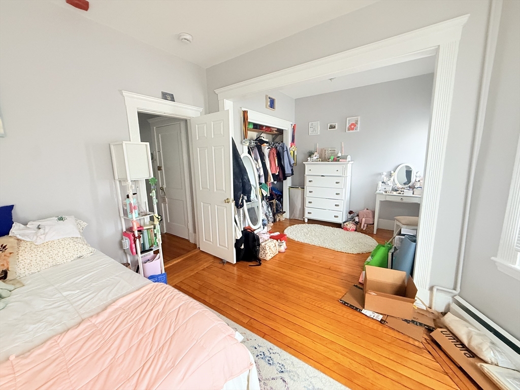 15 Chester Street, Unit 4 Boston, MA 02134 - Photo 12 of 20 a bedroom with a bed and a large mirror on the dresser