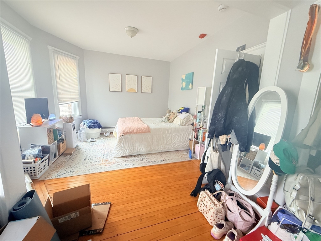 15 Chester Street, Unit 4 Boston, MA 02134 - Photo 13 of 20 a bedroom with bed and wooden floor