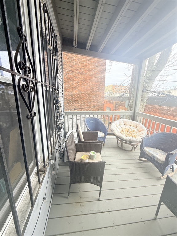 15 Chester Street, Unit 4 Boston, MA 02134 - Photo 19 of 20 a living room with furniture and a floor to ceiling window