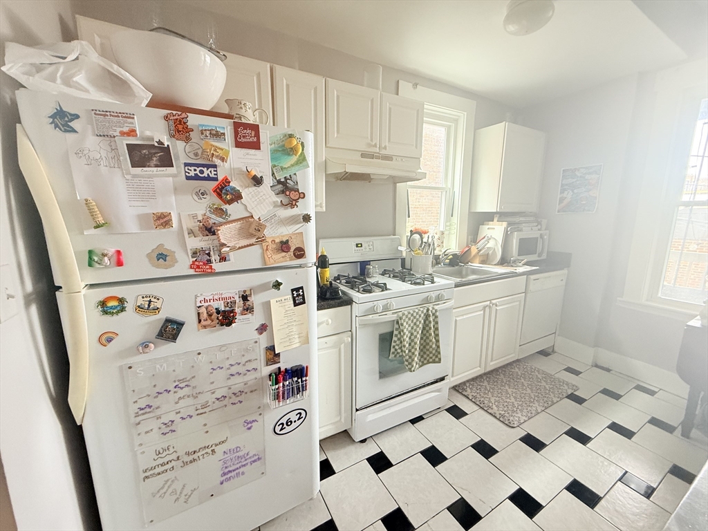 15 Chester Street, Unit 4 Boston, MA 02134 - Photo 3 of 20 a kitchen with stainless steel appliances a stove a sink and a refrigerator
