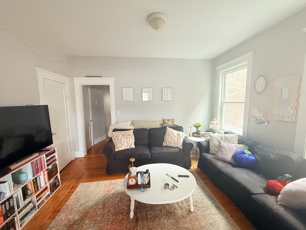 15 Chester Street, Unit 4 Boston, MA 02134 - Photo 4 of 20 a living room with furniture and a flat screen tv