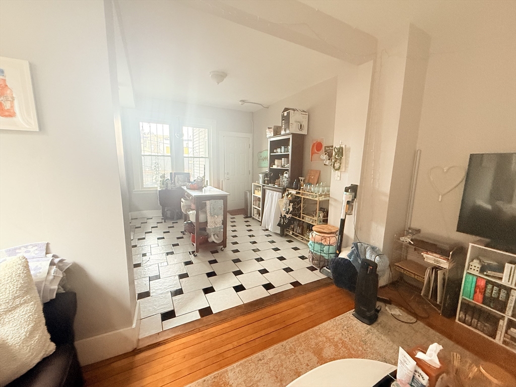 15 Chester Street, Unit 4 Boston, MA 02134 - Photo 6 of 20 a living room with furniture or couch and a bookshelf