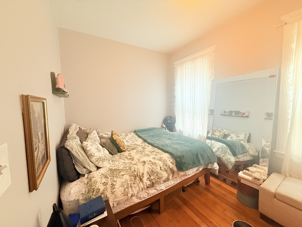 15 Chester Street, Unit 4 Boston, MA 02134 - Photo 10 of 20 a bedroom with furniture and a bed