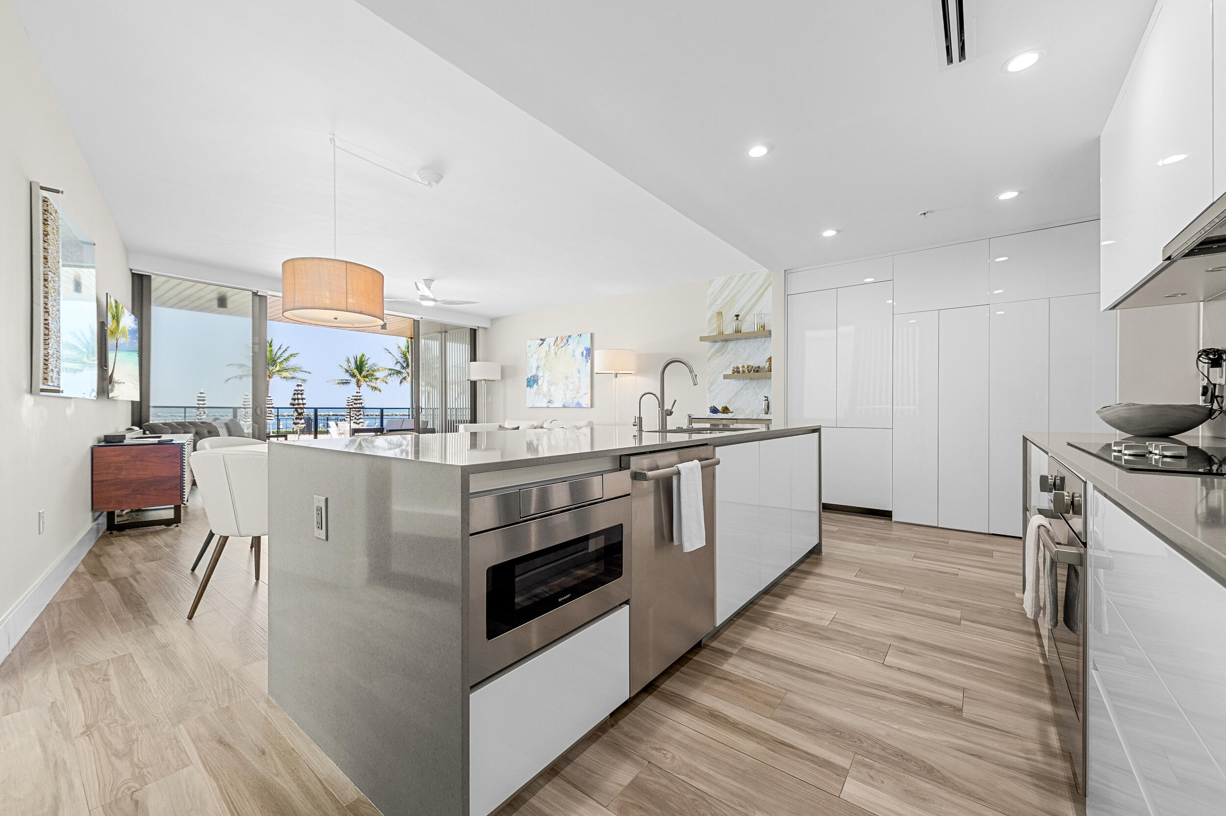 106 Inlet Way, Unit 103 Singer Island, FL 33404 - Photo 12 of 29 a kitchen with stainless steel appliances kitchen island granite countertop a stove and a sink