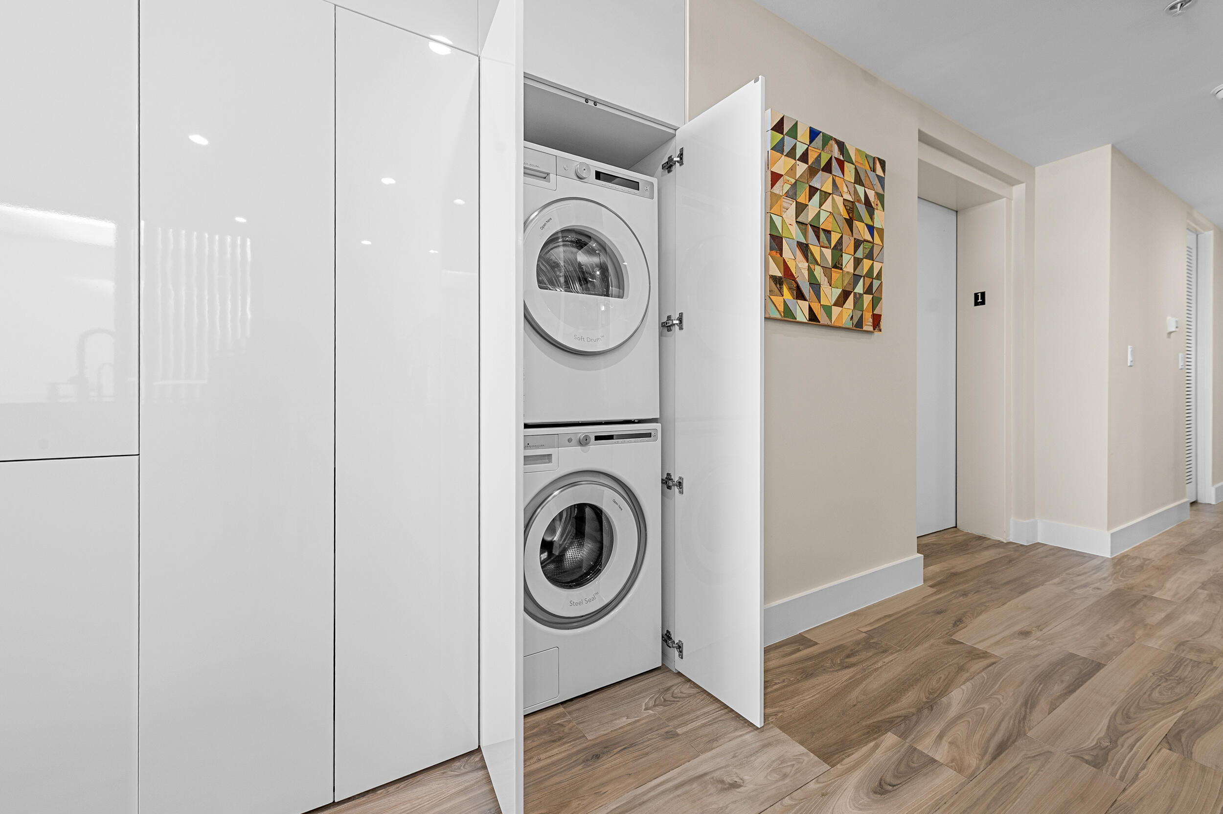 106 Inlet Way, Unit 103 Singer Island, FL 33404 - Photo 13 of 29 a utility room with dryer and washer