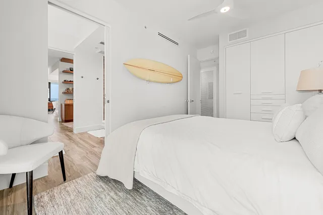 a bedroom with a bed and a chair in it