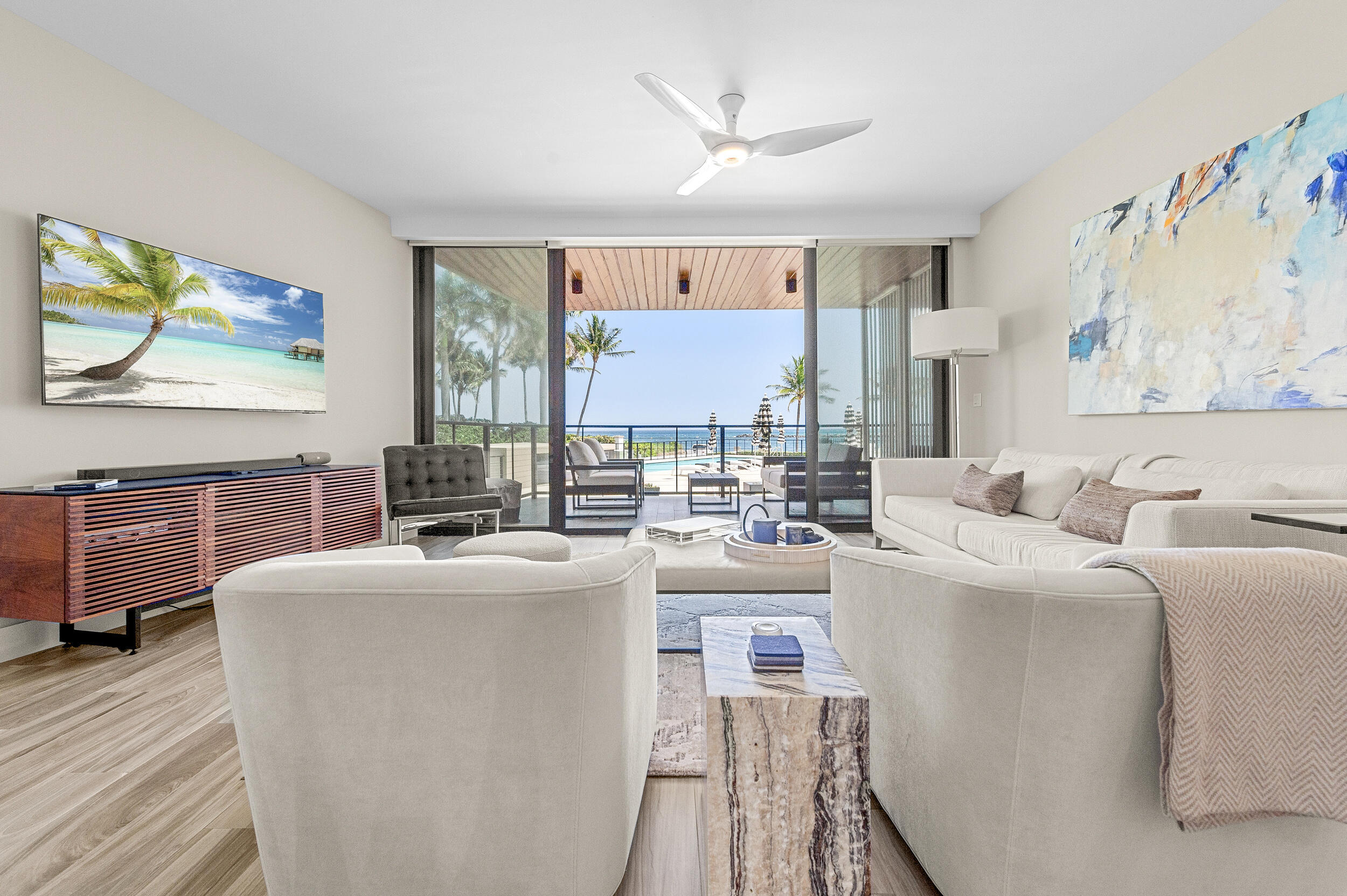 106 Inlet Way, Unit 103 Singer Island, FL 33404 - Photo 2 of 29 a living room with furniture and a flat screen tv