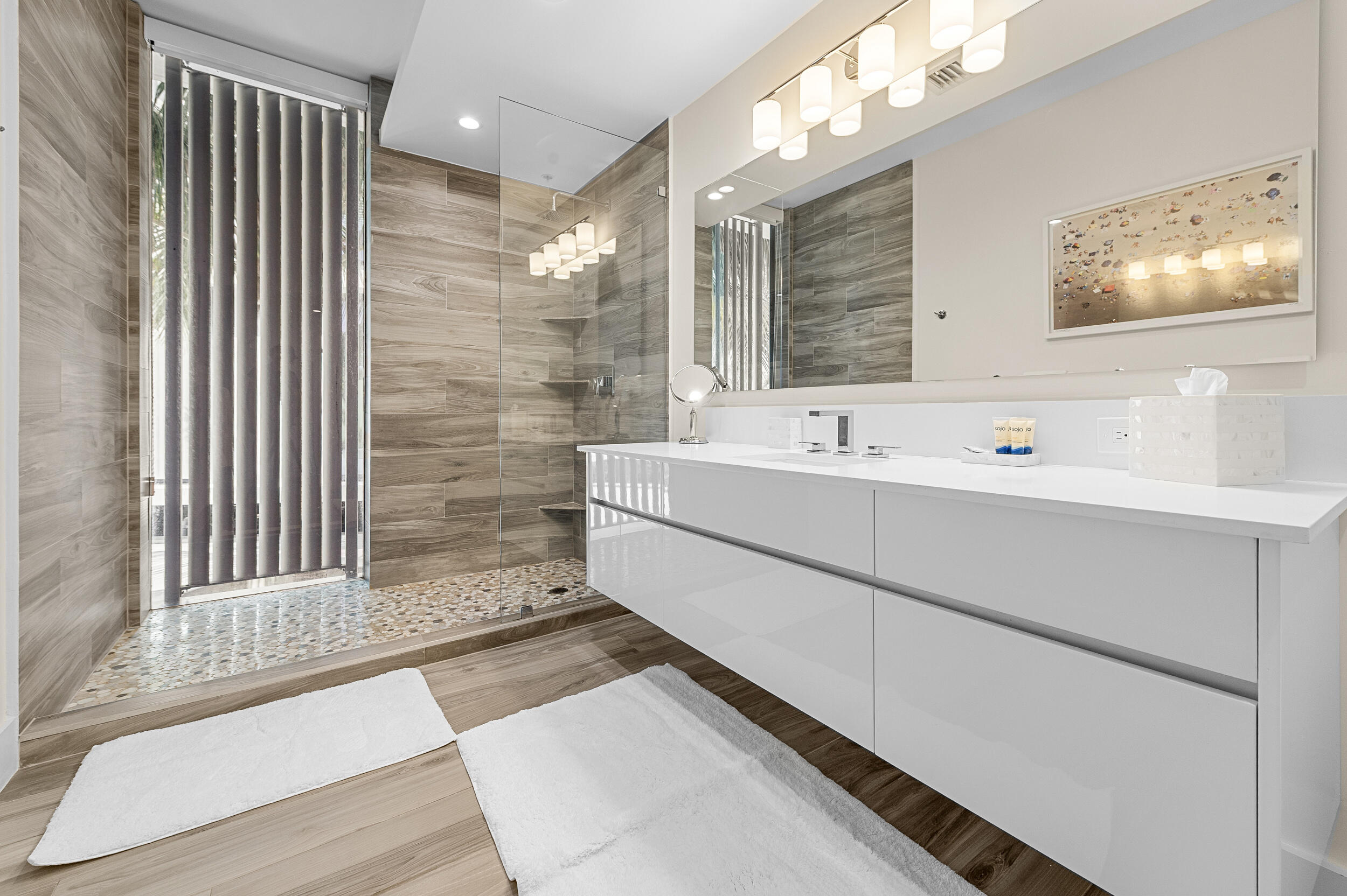 106 Inlet Way, Unit 103 Singer Island, FL 33404 - Photo 21 of 29 a bathroom with a sink mirror and a bathtub