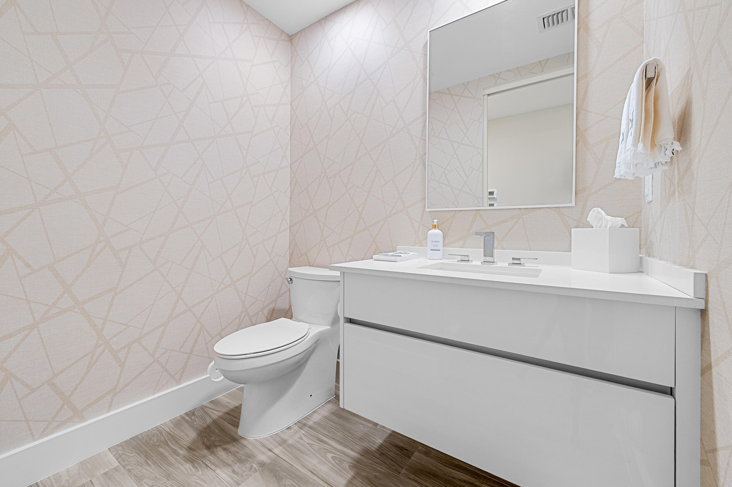 106 Inlet Way, Unit 103 Singer Island, FL 33404 - Photo 27 of 29 a bathroom with a sink toilet and a mirror