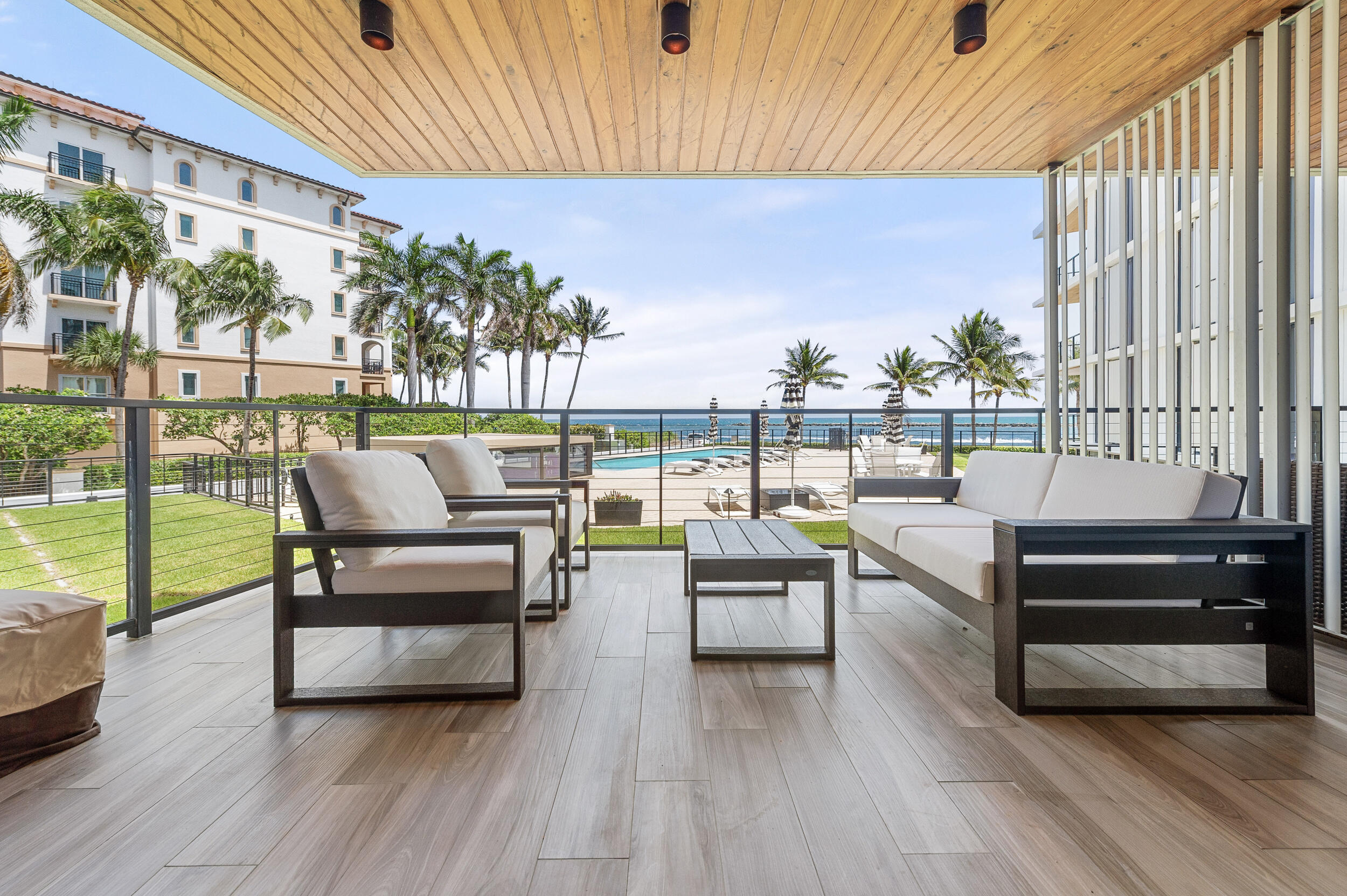 106 Inlet Way, Unit 103 Singer Island, FL 33404 - Photo 3 of 29 a view of a patio with couches and pool