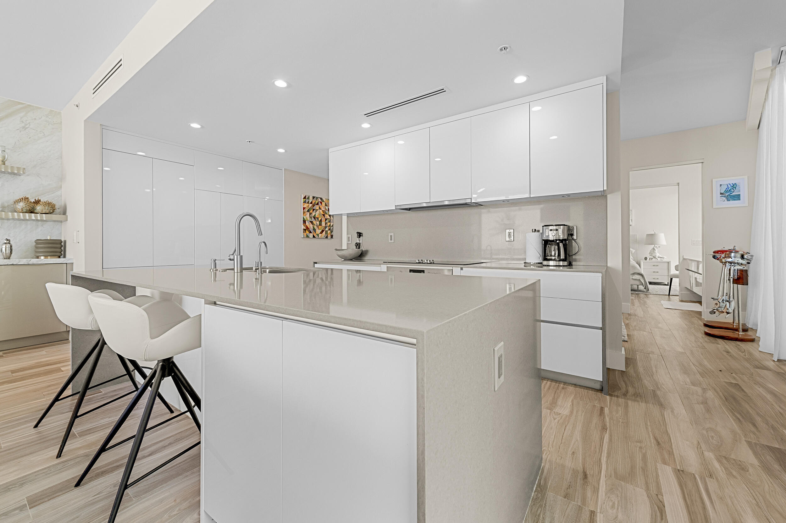 106 Inlet Way, Unit 103 Singer Island, FL 33404 - Photo 9 of 29 a kitchen with a sink cabinets stainless steel appliances and dining table
