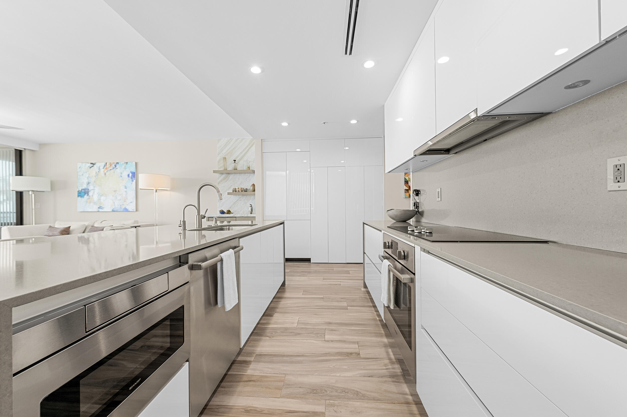 106 Inlet Way, Unit 103 Singer Island, FL 33404 - Photo 10 of 29 a large kitchen with a large counter top space a sink stainless steel appliances and cabinets