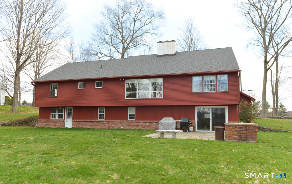174 SW Road Waterbury, CT 06708 - Photo 15 of 17 a front view of a house with a yard table and chairs