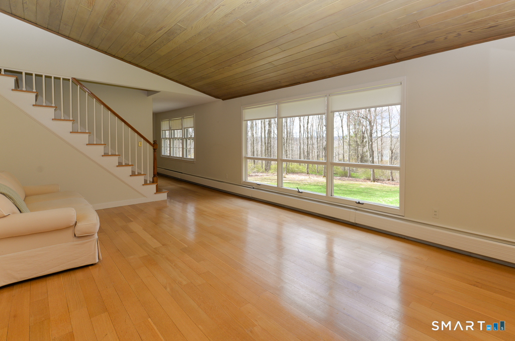 174 SW Road Waterbury, CT 06708 - Photo 3 of 17 a view of an empty room with wooden floor and a window