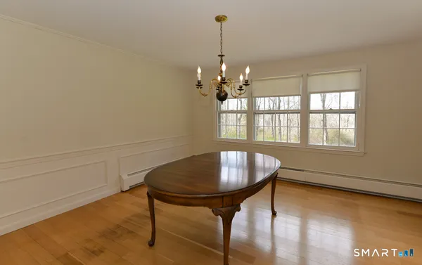 a dining room with furniture and window