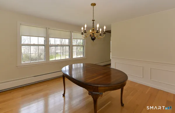 a view of a dining room with furniture and window