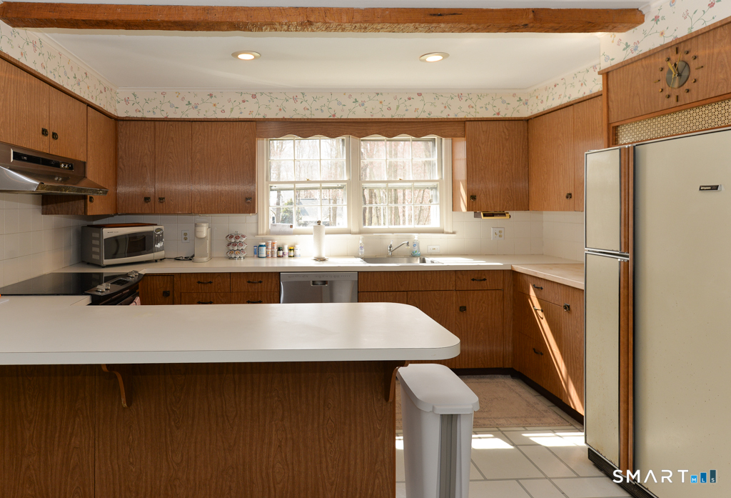 174 SW Road Waterbury, CT 06708 - Photo 6 of 17 a kitchen with stainless steel appliances a sink stove and refrigerator