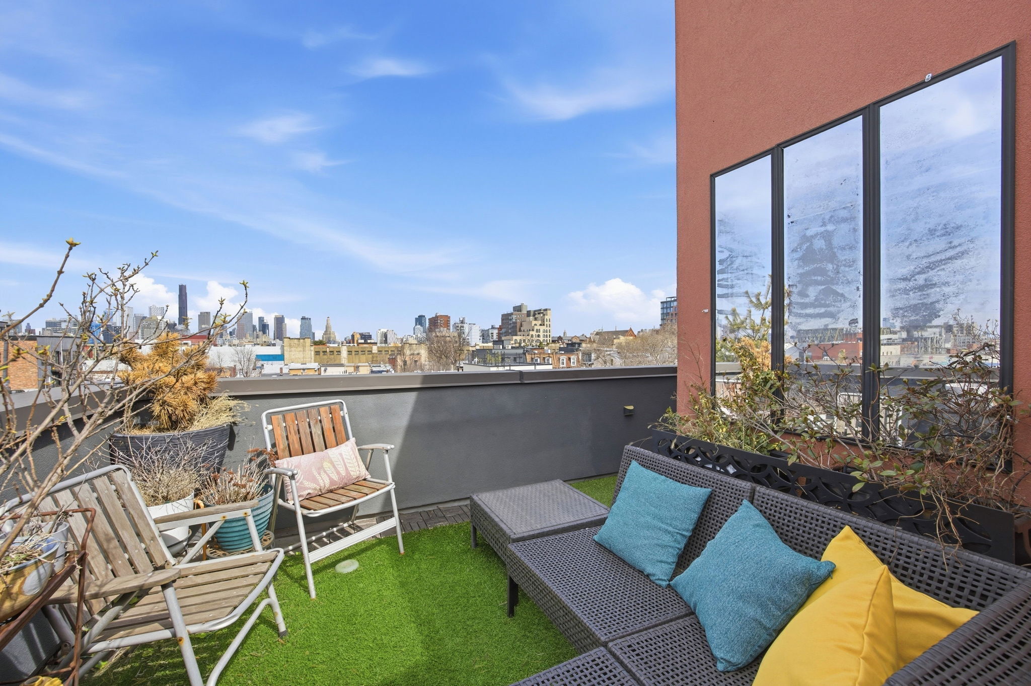 175 12th Street, Unit 4B Brooklyn, NY 11215 - Photo 23 of 27 a view of a balcony with chairs and a floor to ceiling window
